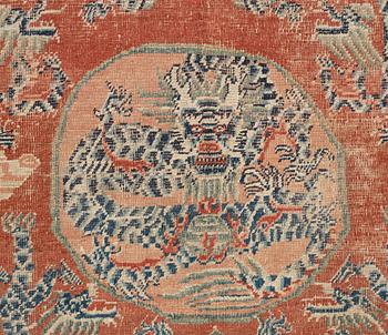 A red based Chinese five clawed dragon carpet, Qing dynasty, presumably 18th Century.