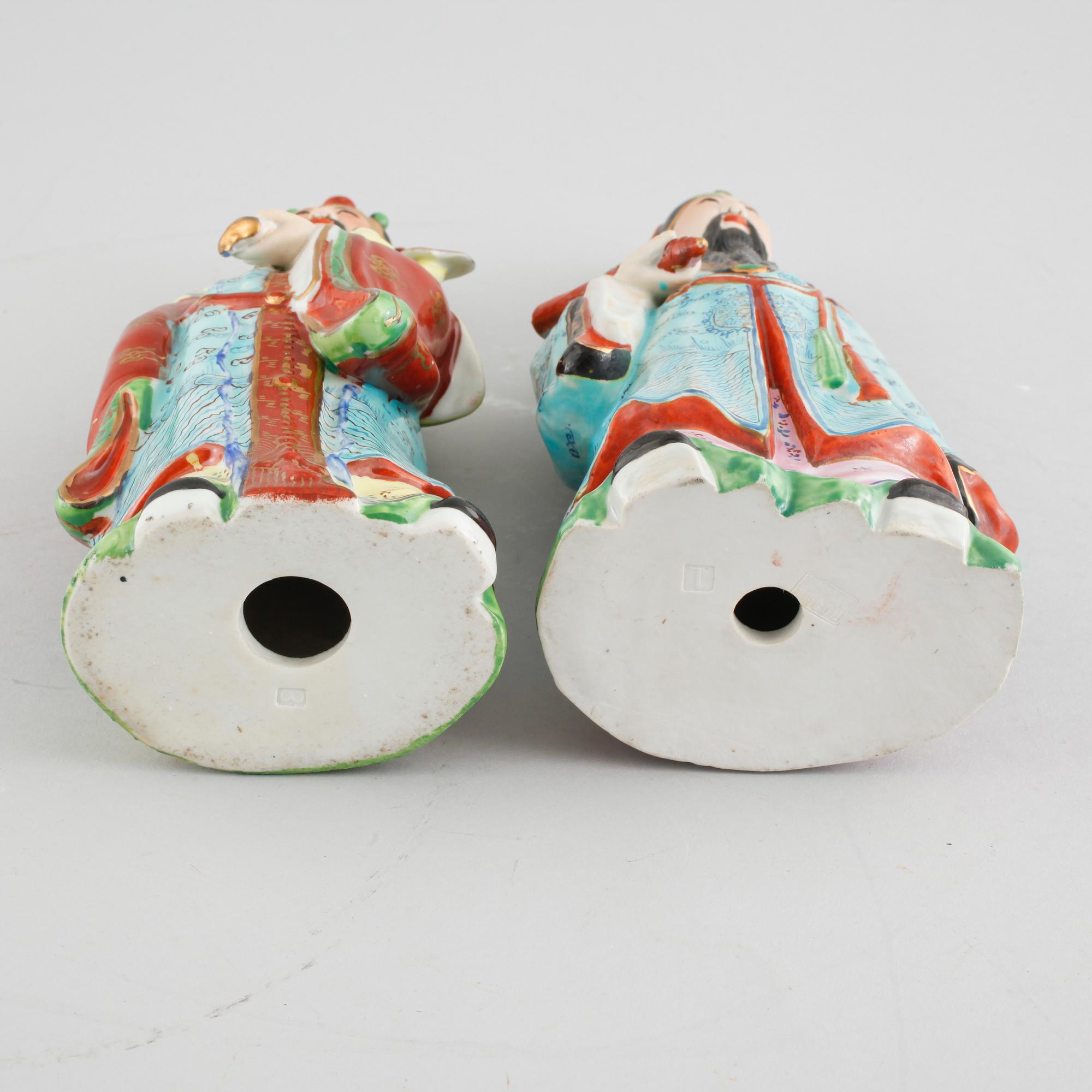 A pair of chinese figurines.