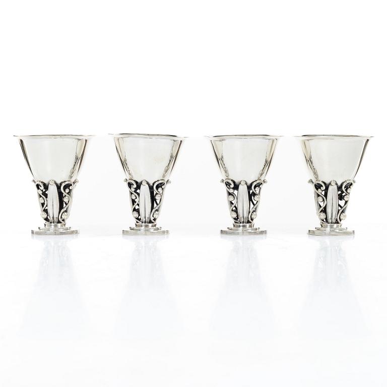 Evald Nielsen, four sterling silver beakers/cups on a foot, Denmark 20th century.