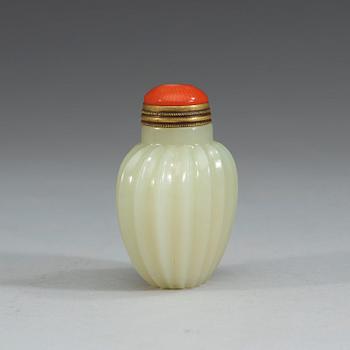 A finely carved nephrite snuff bottle with stopper, China.
