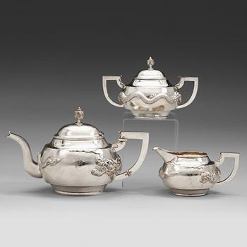 442. A Chinese three piece silver tea set, early 20th Century.
