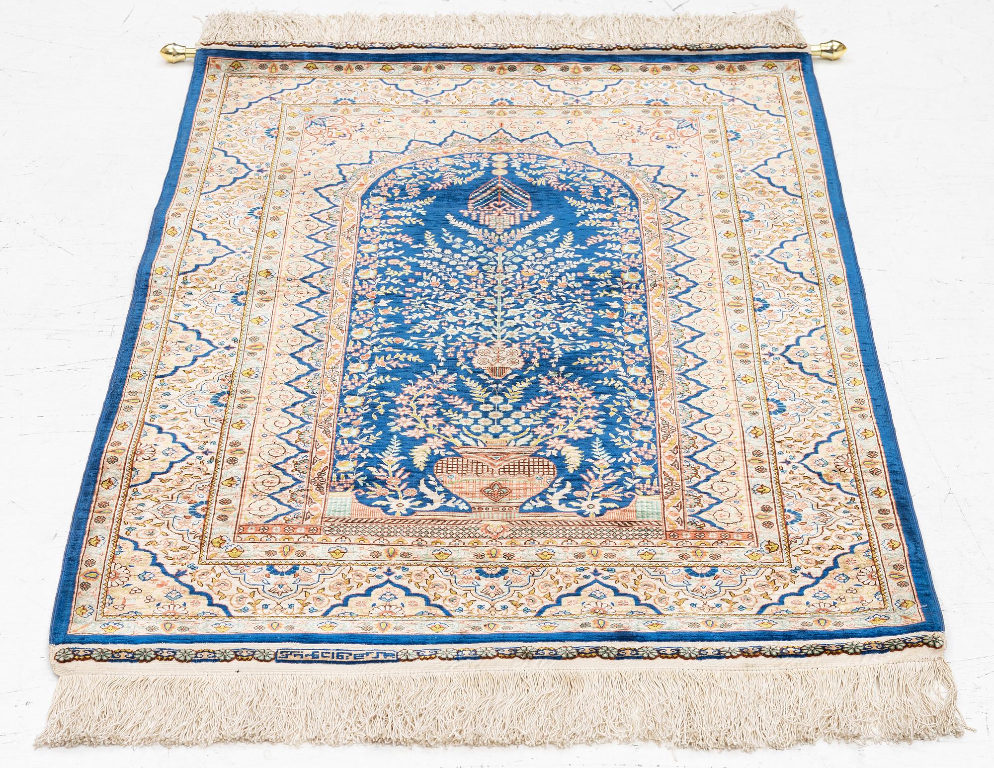 A semi-antique silk Hereke rug, West Anatolia, signed c. 107 x 72 cm.