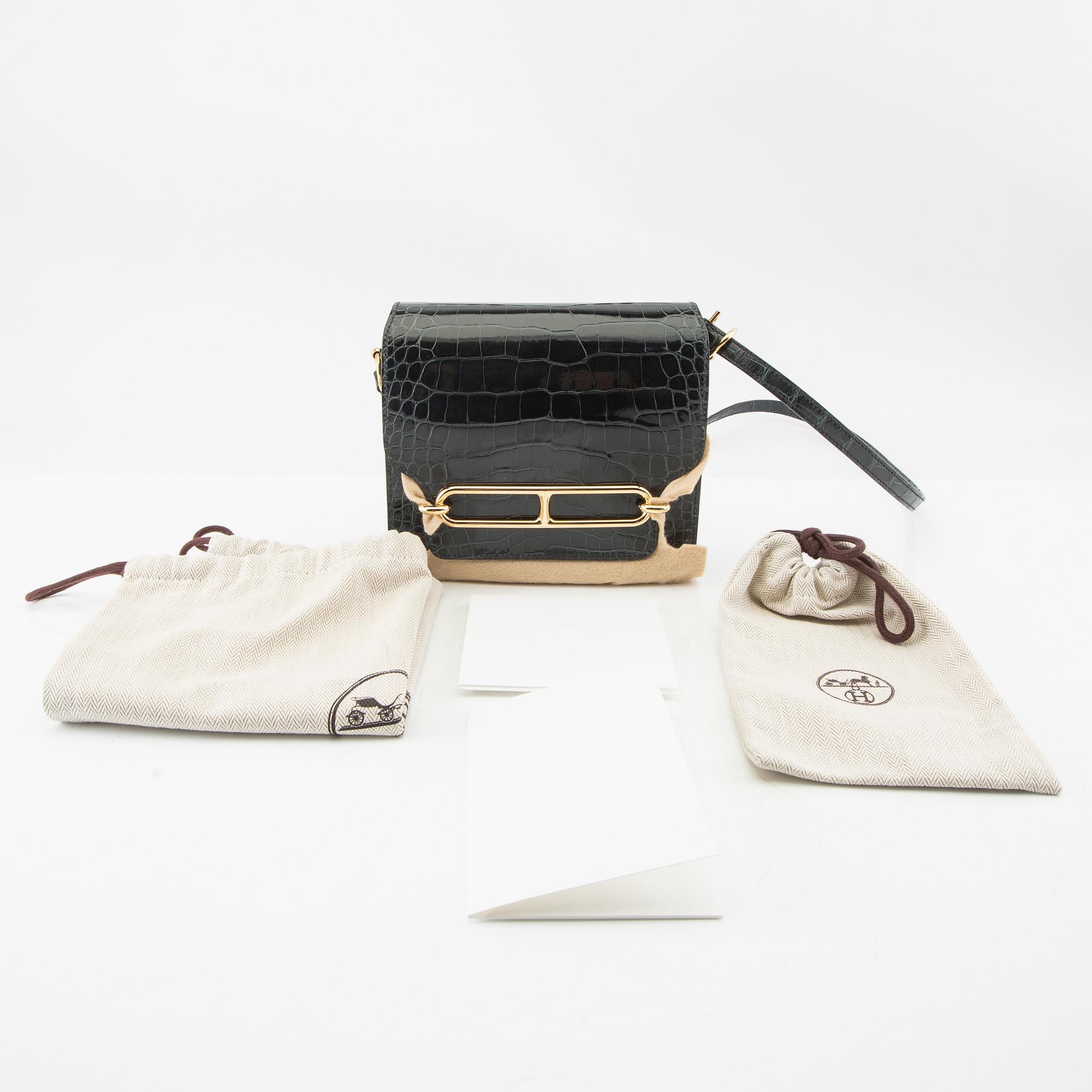 Hermès, bag "Green Shiny Alligator Mini Roulis 18 Permabrass Hardware" 2021.