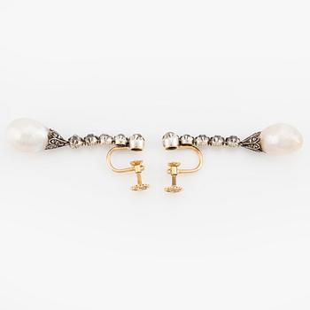 A pair of silver and gold earrings with drop-shaped pearls and old- and rose-cut diamonds.