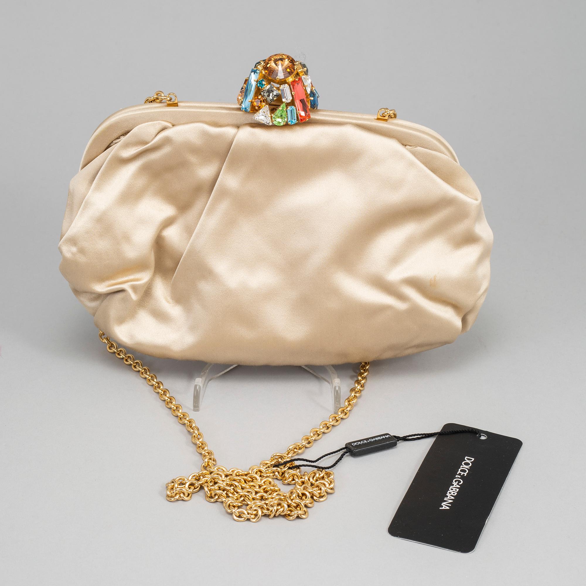 DOLCE & GABBANA, a satin clutch.