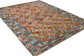 An Afghan kelim carpet, c. 397 x 308 cm.