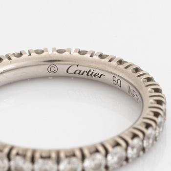 A Cartier platinum eternity ring set with round brilliant-cut diamonds.