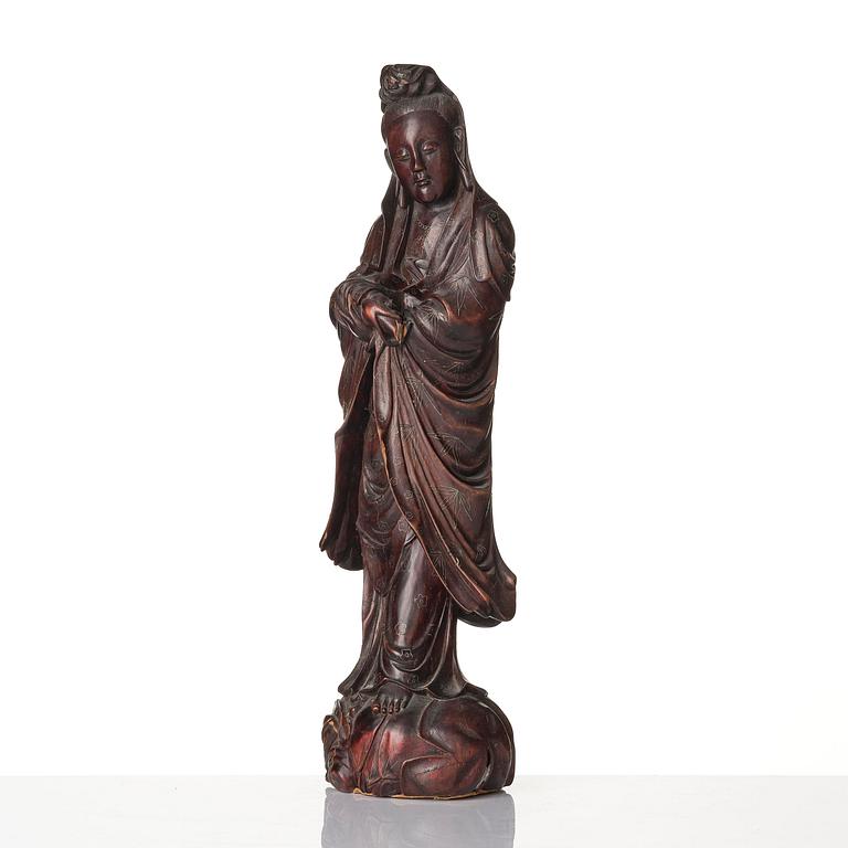 A wooden sculpture of Guanyin with metal inlay, Qing dynasty.