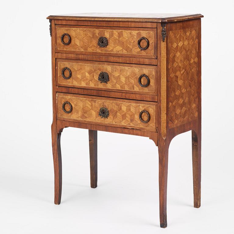 A Louis XVI-style parquetry commode, circa 1900.
