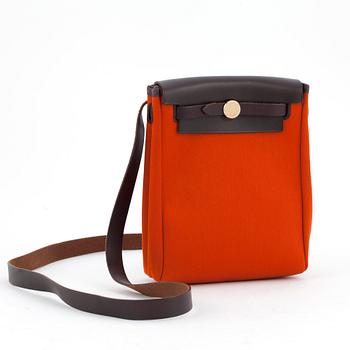 680. HERMÈS, a orange and red exchangeable shoulder bag, "Herbag TPM".