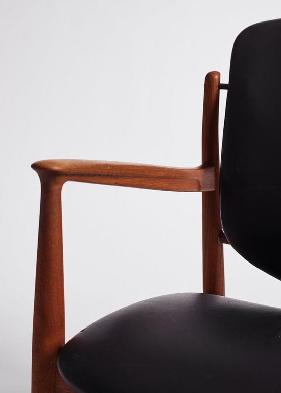 Finn Juhl, a teak and black leather 'model 136' easy chair, France & Daverkosen, Denmark 1950-60s.