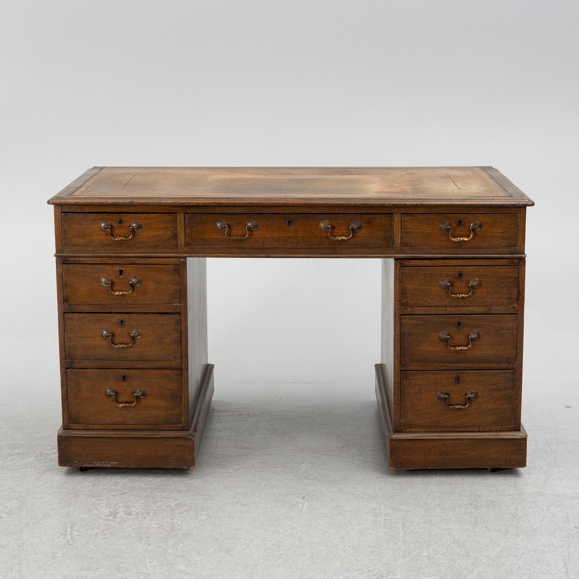 A mahogany and mahogany veneer desk with desk chair, 20th Century.