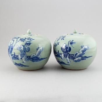 A pair of Chinese celadon glazed and blue and white jars with covers, 20th century.