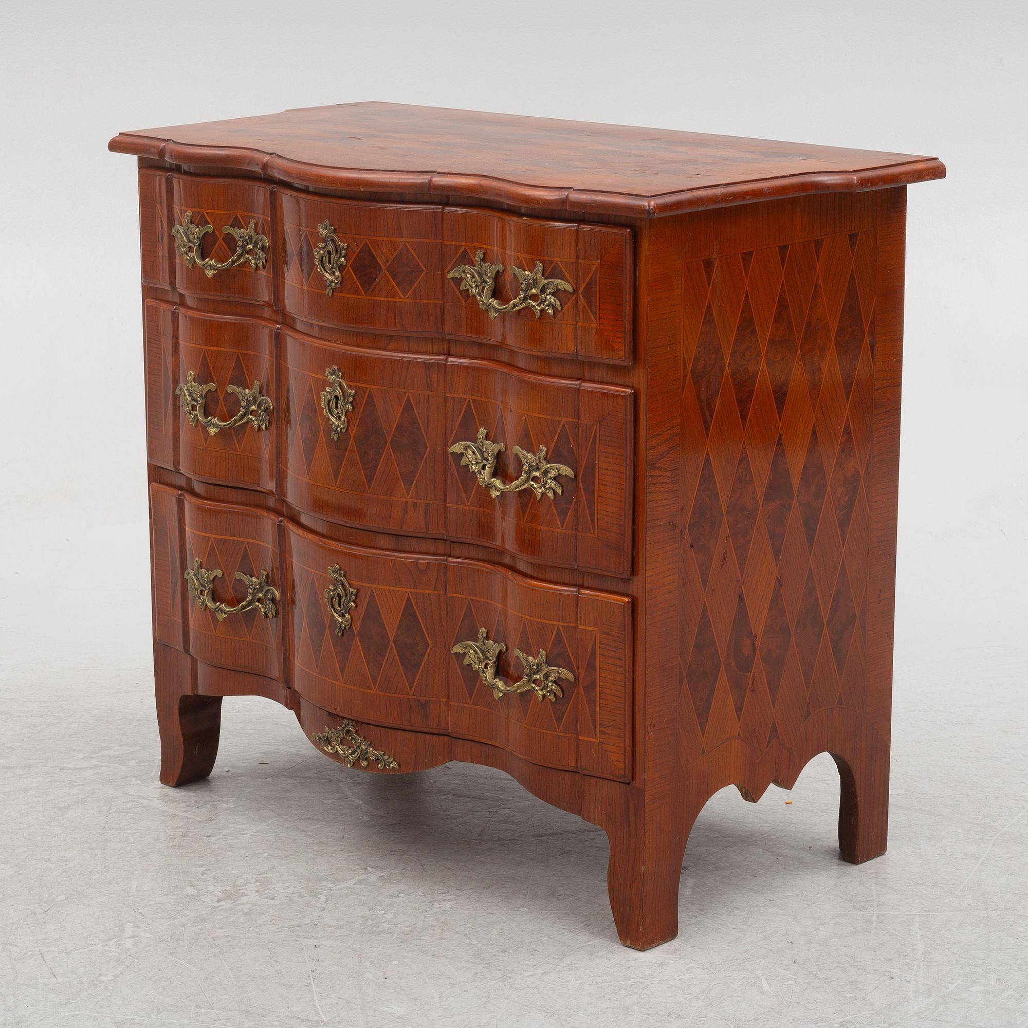 A Baroque style chest of drawers, circa 1900.