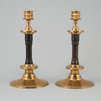 A pair of early 20th century brass and wood candlesticks, no 87, Gusums Bruk, Sweden.