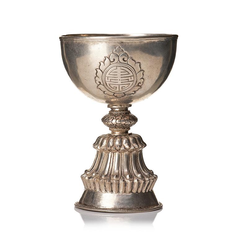 A Tibetan butter lamp, silvered copper, 20th century.