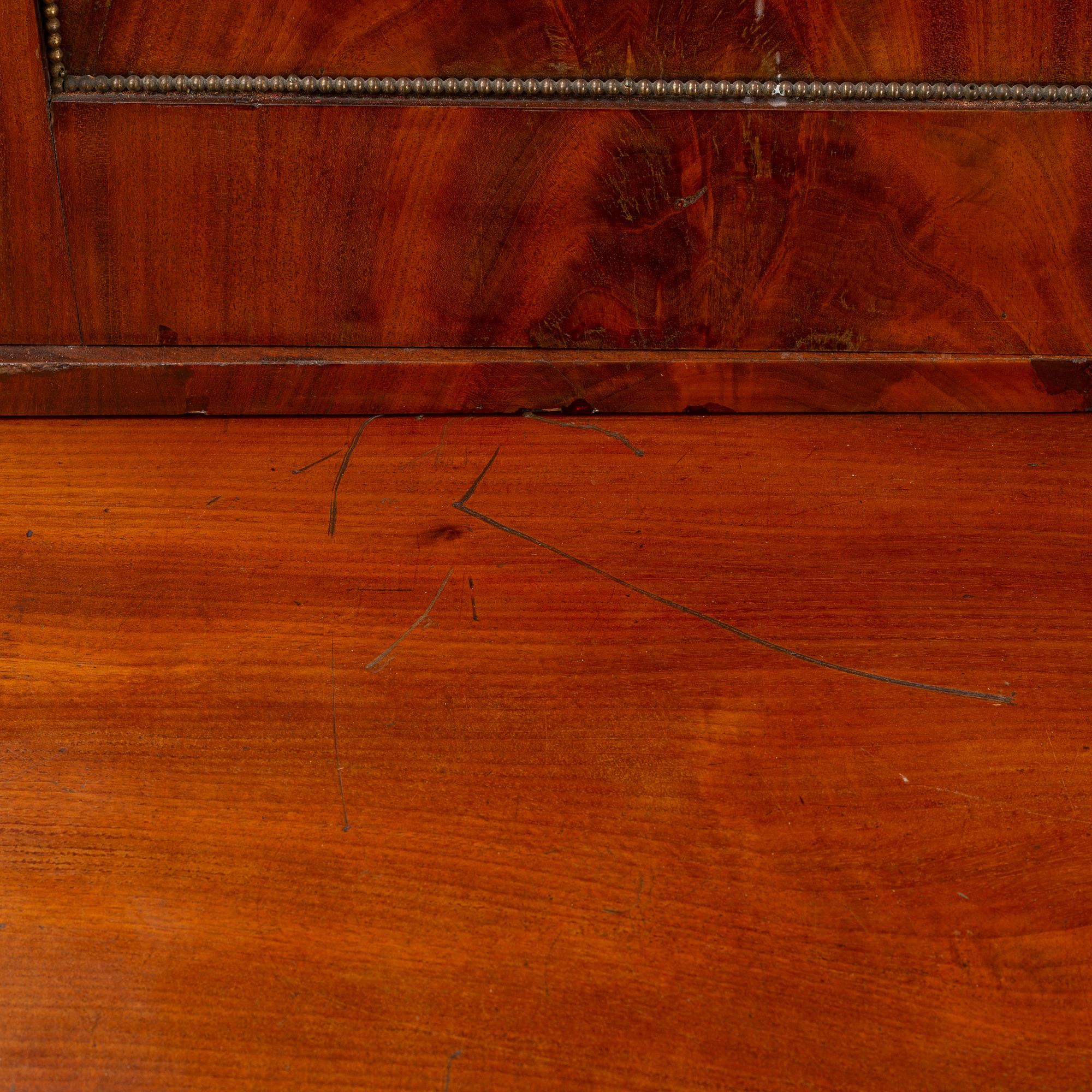 A mahogany veneered Empire cupboard, first half of the 19th century.