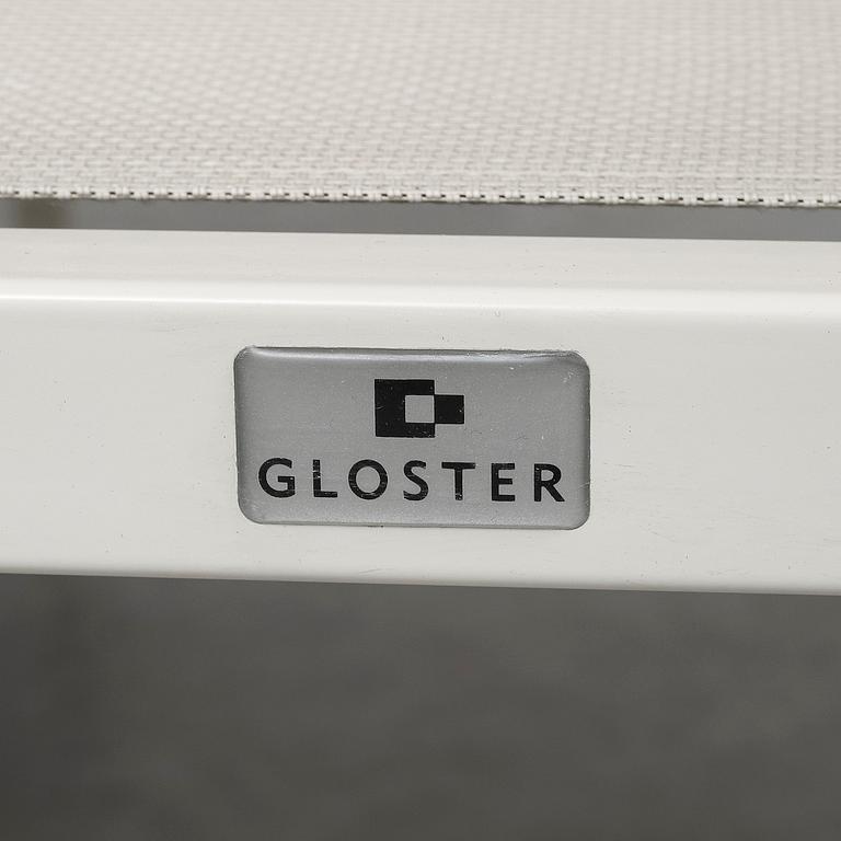 A garden table with four chairs, Gloster.