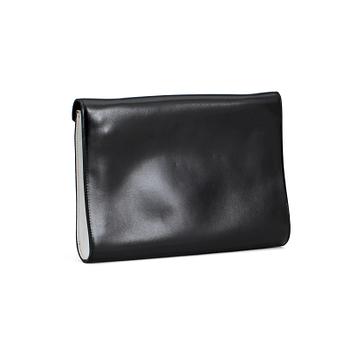 CÉLINE, a black and white leather clutch.