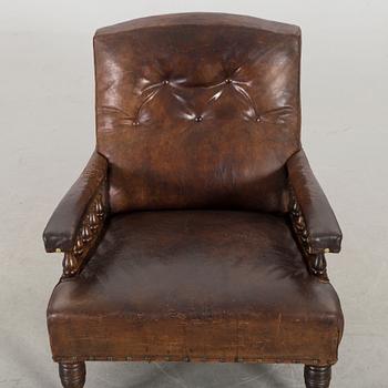 A LEATHER ARMCHAIR early 20th century.