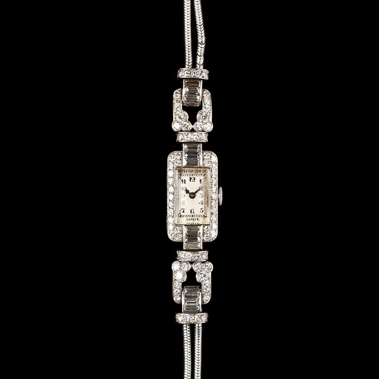 A Patek Philippe ladie's wrist watch, set with baguette- and brilliant cut diamonds, tot. app. 4 cts.