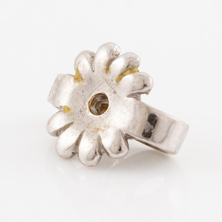 A pair of earrings in 18K white gold set with two round brilliant-cut diamonds, likely Tiffany & Co.