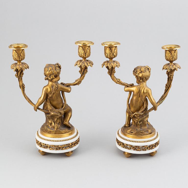 A pair of Louis XVI style gilt bronze and marble two light candelabras, circa 1900.