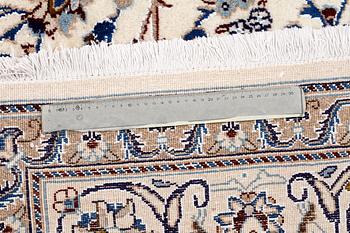 A Nain rug, part silk, 296 x187 cm.