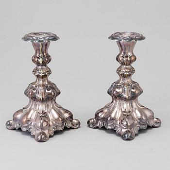 A pair of silver plate Rococo style candle sticks, 20th century.