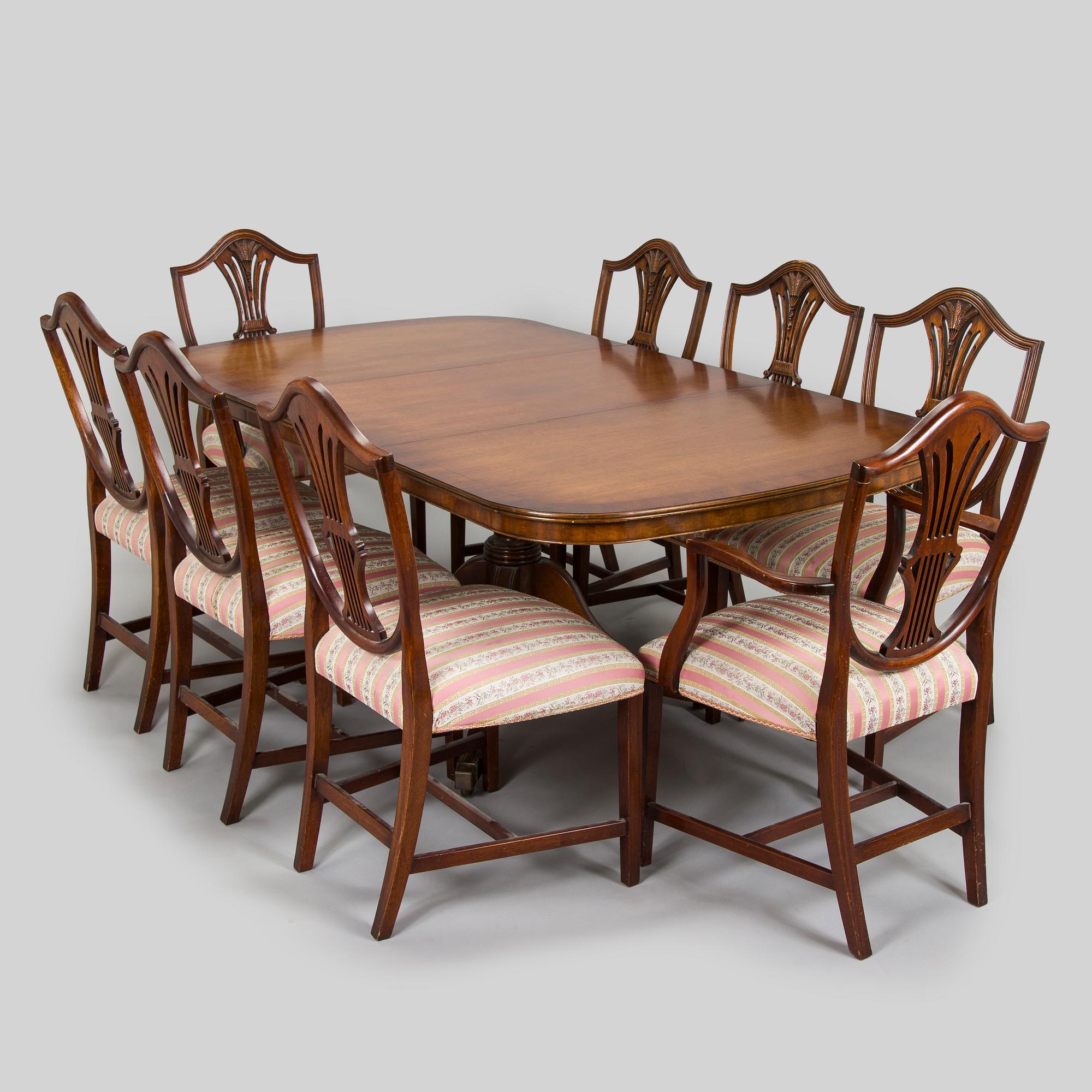 An English dining table and eight chairs, 1970s.