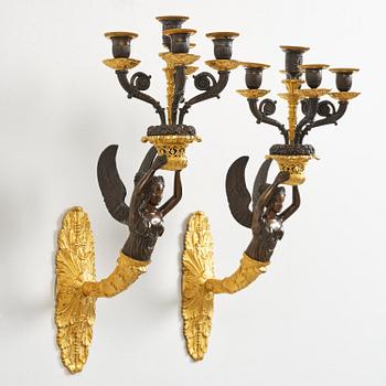 A pair of French Empire five-branch gilt and patinated bronze appliques, first part 19th century.
