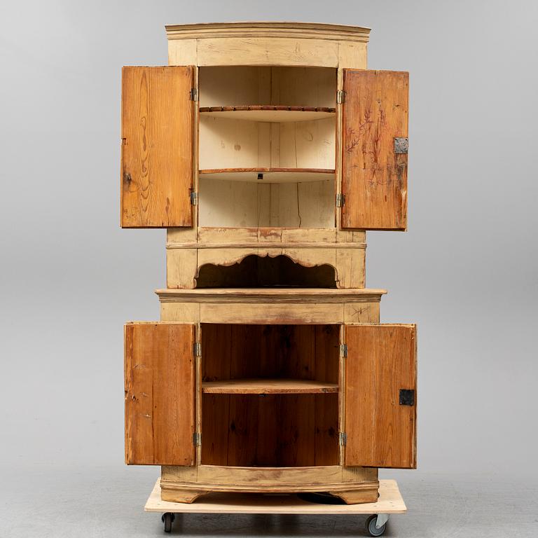 A Swedish late Gustavian corner cabinet in two parts.