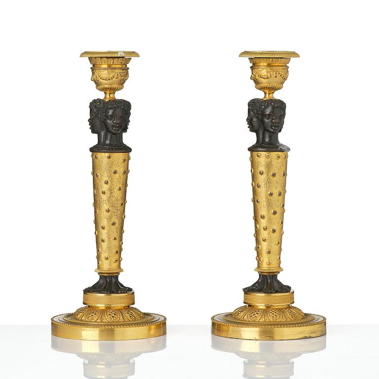 A pair of Napoleon III gilt and patinated bronze candlesticks, later part 19th century.