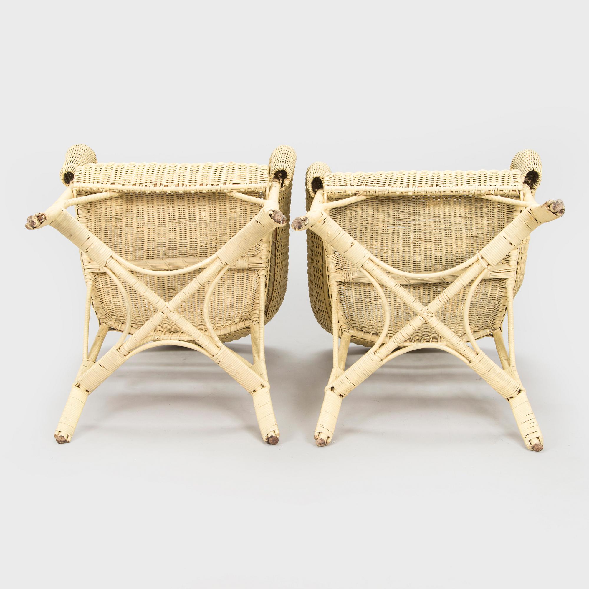 A mid-20th-century three-piece rattan furniture set including two armchairs, and a table.