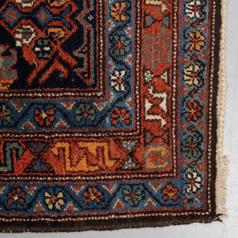 A rug, a semi-antique/an old Garaghan, ca 223 x 135-141 cm.