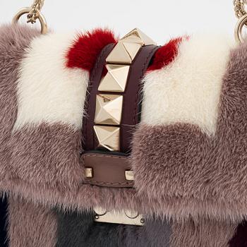 Valentino, a tinted fur, leather and studs bag.