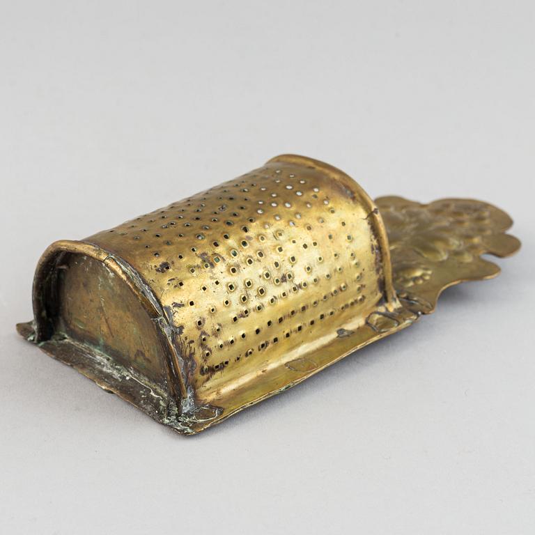 A 17th century brass spoon holder.