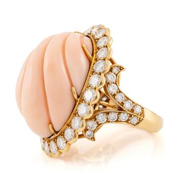 589. An 18K gold and coral Cartier ring set with round brilliant-cut diamonds.
