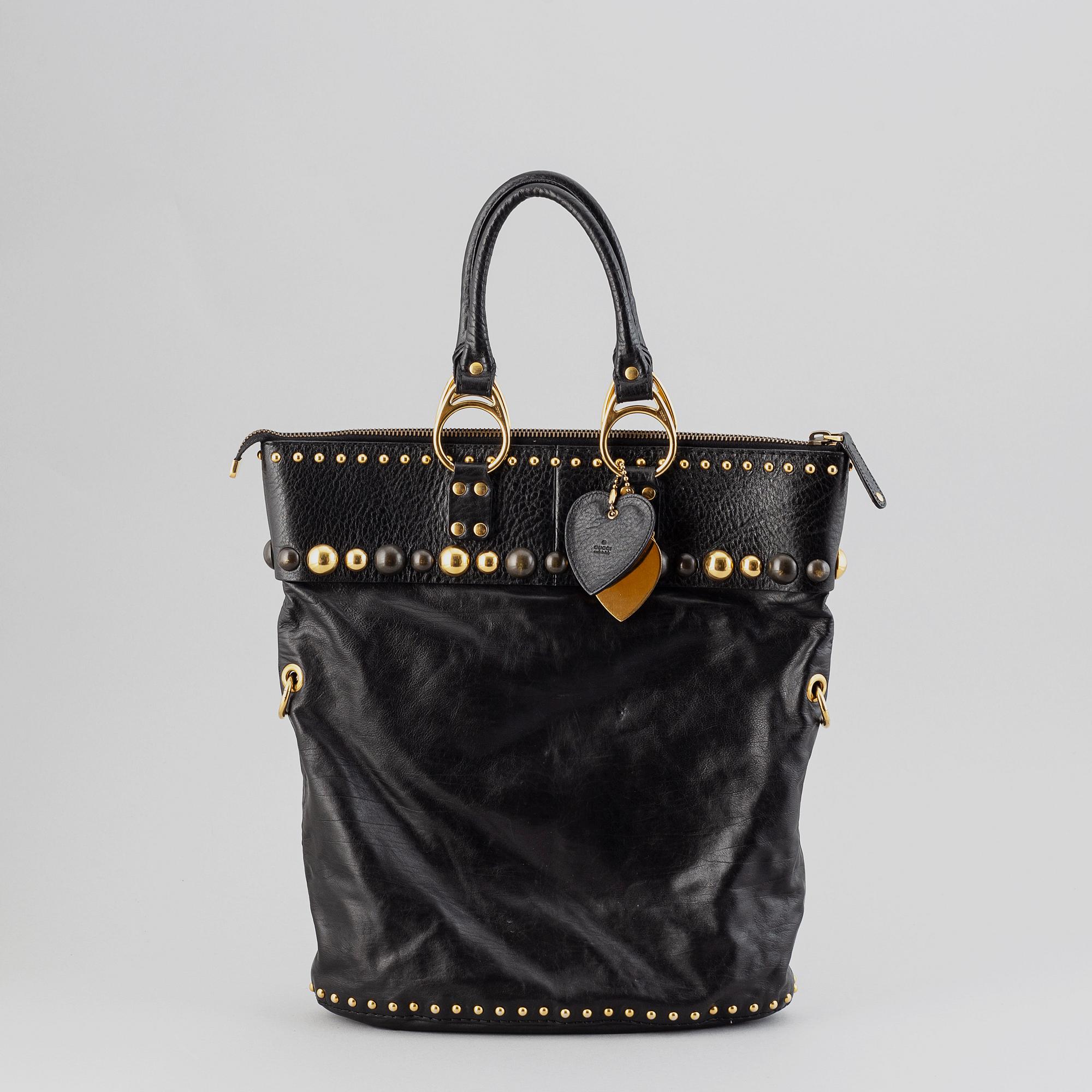 Gucci, a black leather handbag.