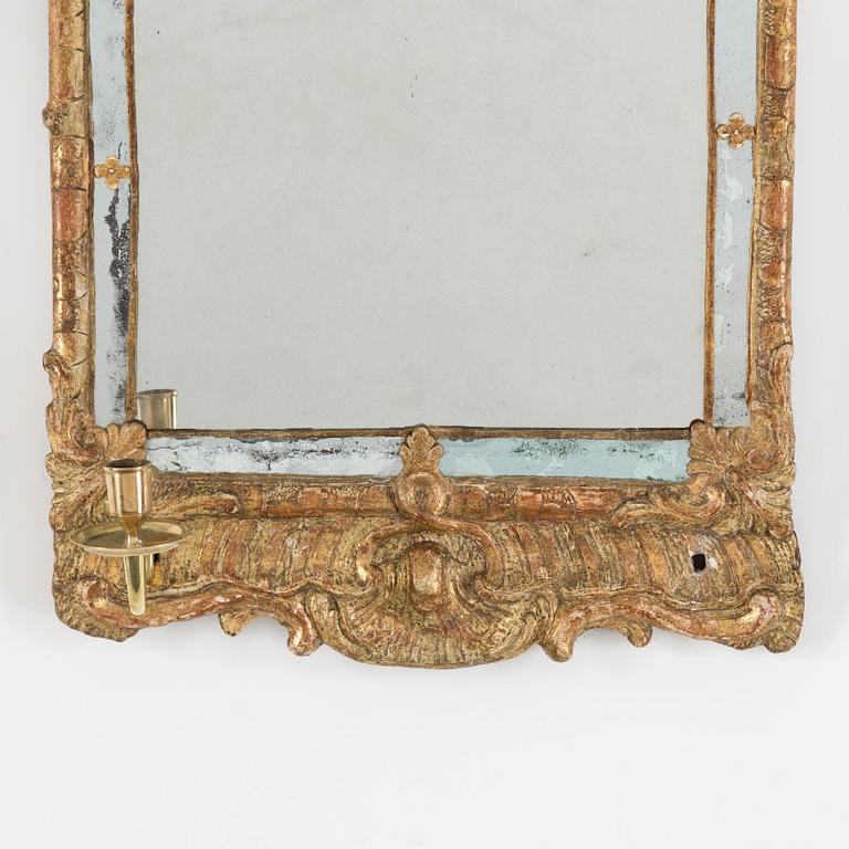A second half of the 18th century rococo mirror sconce.
