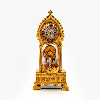 A mid 1800s gilded bronze pocket watch stand and pocket watch.