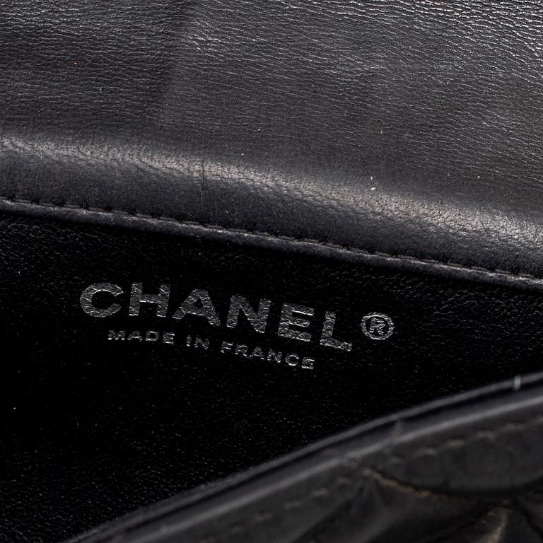 CHANEL, a black leather 'Extra mini flap bag' 2012-13.