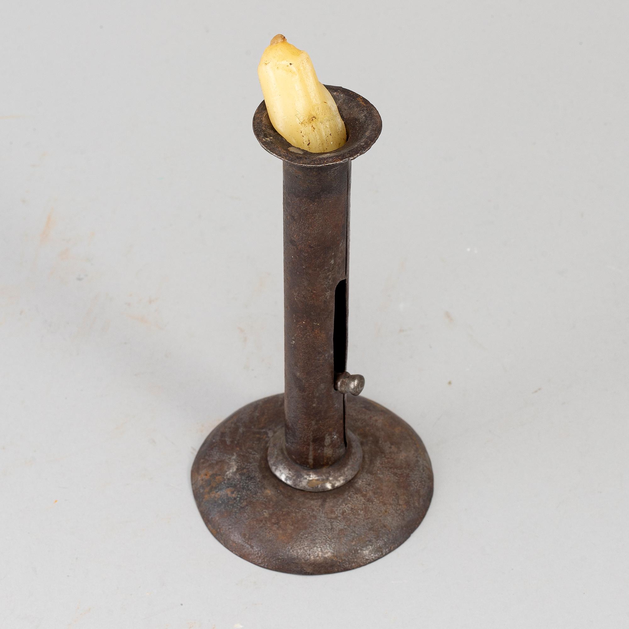 An 18th century tinplate candlestick.