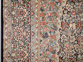 A Kirman Laver carpet, 'Millefleur', approx. 492 x 350 cm.