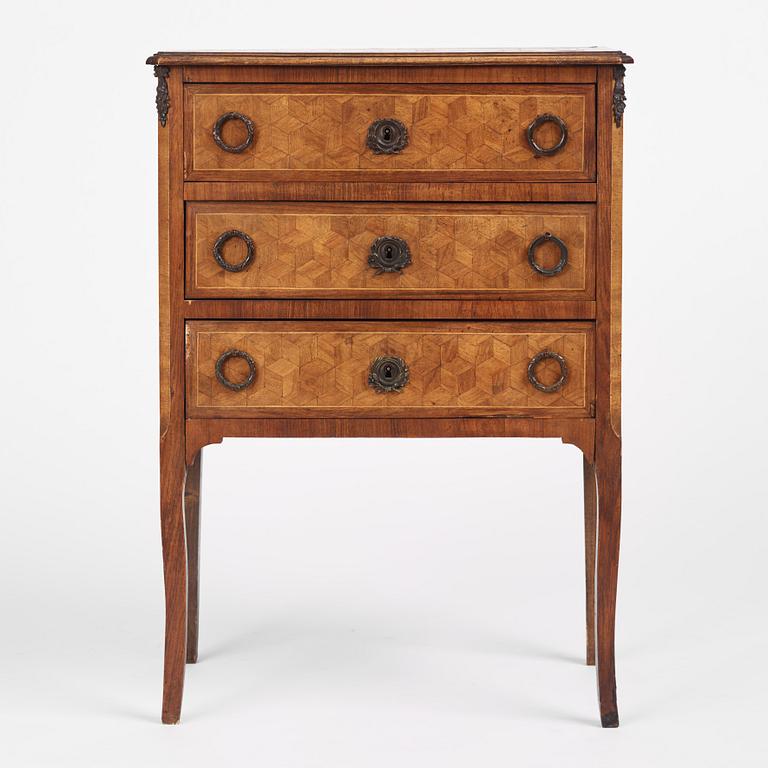 A Louis XVI-style parquetry commode, circa 1900.
