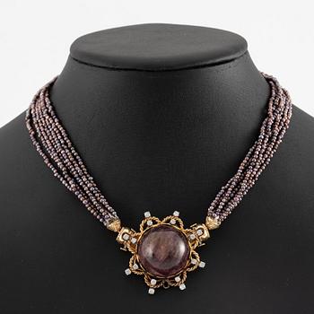 Multi-strand pearl necklace with two clasps set with carved coral, cabochon-cut tourmaline, and brilliant-cut diamonds.