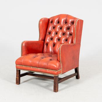 A late 20th century wingback leather chair.