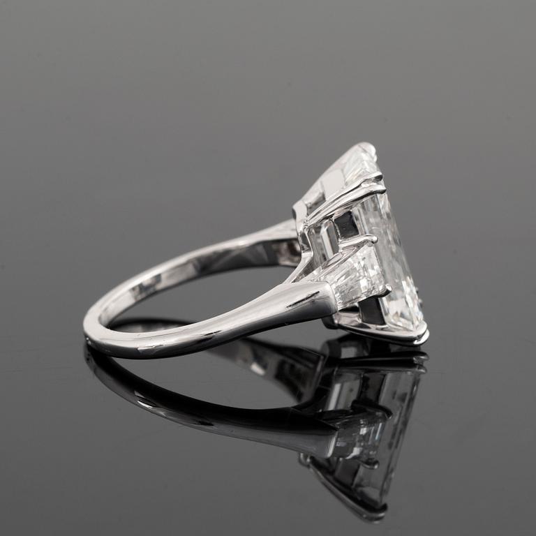 A platinum ring set with an emerald-cut diamond.