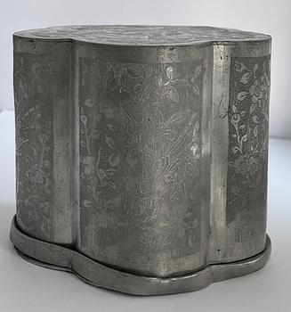 A set of Chinese pewter tea caddies in a container, Qing dynasty, 19th century.