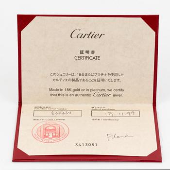 An 18K white gold Cartier "Spartacus" bracelet with two charms.